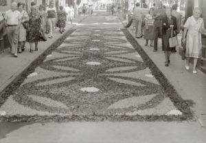 Vista parcial d'unes catifes de flors durant el dia de Corpus, al passeig de Miquel Blay, o Firal. ACGAX. Servei d'Imatges. Col·lecció L'Abans. Cessió de Pep Roura Bendicho. Autor: Pep Roura Bendicho, 1981.